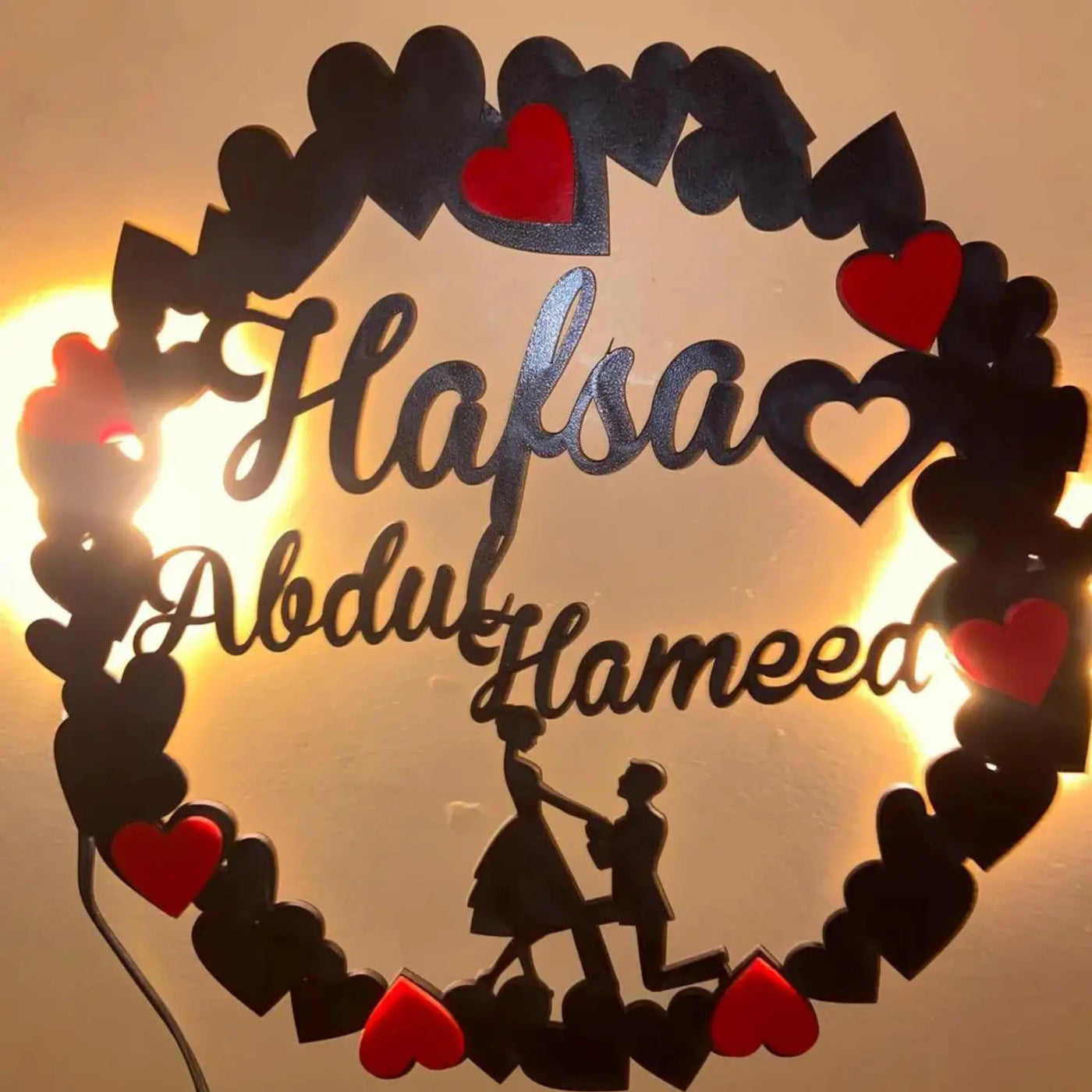 Personalized heart-shaped couple name frame in wood with optional LED lights. Ideal for gifting on special occasions.